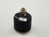 a close up of a ring sitting on top of a black box