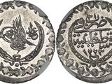 a silver coin with an image of a bird on it