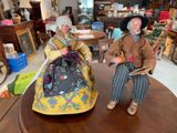 two figurines of a man and a woman on a table