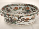 a white bowl with flowers on it on a table