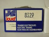 a close up of a box of train electric trains on a table