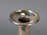 a silver vase that is sitting on a table