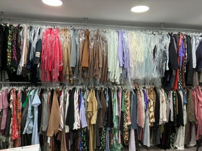 une armoire pleine de vêtements et des vêtements suspendus à un portant