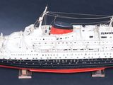 a model of a ship on a stand on a black background