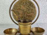 an antique brass mortar set with three bowls and a wooden handle