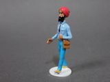a small figurine of a man with a red turban on his head