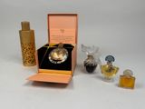 a small box with a perfume bottle and a perfume bottle in it
