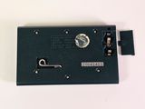 a close up of a black electronic device on a white surface