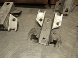 several pieces of metal sitting on top of a metal table