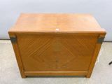 an old wooden chest with a metal latch on the front
