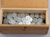 a box full of silver coins sitting on a table
