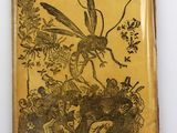 un vieux livre dont la couverture est ornée d'une illustration représentant un insecte