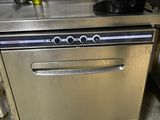 a stainless steel dishwasher in the middle of a kitchen