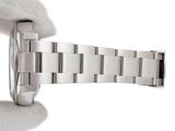 a person holding a watch in their hand on a white surface
