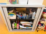 a metal cabinet with a bunch of items inside of it