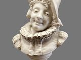 a white bust of a child with a hat on it