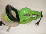 a green corded blower sitting on top of a table