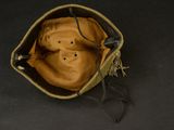 a brown hat with a face on it sitting on a black surface