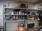 a garage with a lot of paint and tools on the shelves