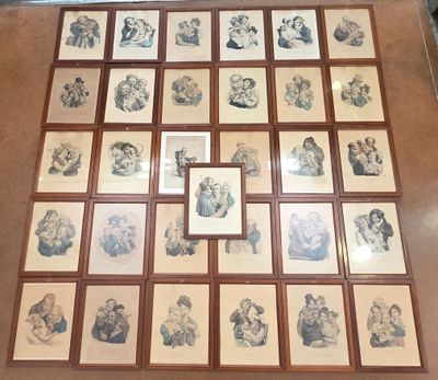 a lot of framed pictures on the floor of this room