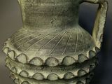 a green vase that is sitting on a table
