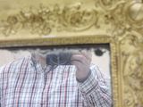 a man that is taking a picture of himself in a mirror
