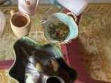 a glass table with a vase, tea pot, and other items on it