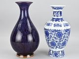 two blue and white vases sitting next to each other on a table
