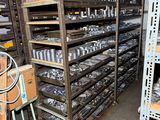 many shelves of tools in a garage with a lot of shelves