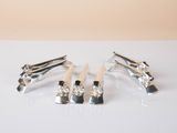 four toothbrushes sitting on a table with a white background