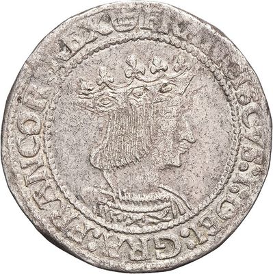 a silver coin with a crown on top of it