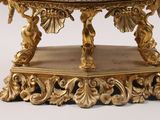 a gold table with a marble top on a white background