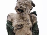 a statue of a man holding a baby in his arms