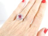 an image of a woman ' s hand with a diamond and ruby ring