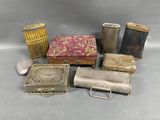 several different types of tins and other metal items on a table