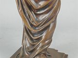 bronze statue of a woman holding a vase on a marble base