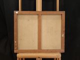 an easel with a painting on top of it sitting on a table