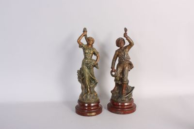 pair of antique bronze figurines of a woman and a boy