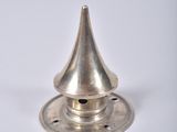 an image of a silver metal candle holder on a white surface