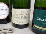 several bottles of wine are lined up on a table next to a bottle opener