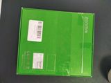 a green box with a white sticker on it