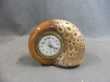 a small clock sitting on top of a table