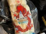 a bag of rice sitting on top of a pile of trash