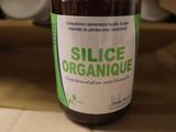 a bottle of liquid sitting on a counter in a kitchen