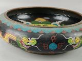 a black bowl with a dragon design on it