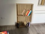 a book shelf in the corner of a room with books on it