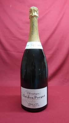 bottle of sparkling wine on a red background with a pink backdrop