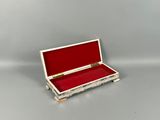 a small white box with a red lid on a table