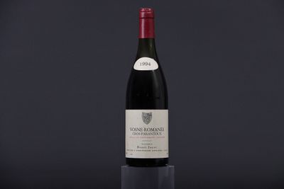 a bottle of red wine sitting on top of a table