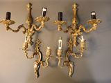 a wall mounted candle holder with three candles on it